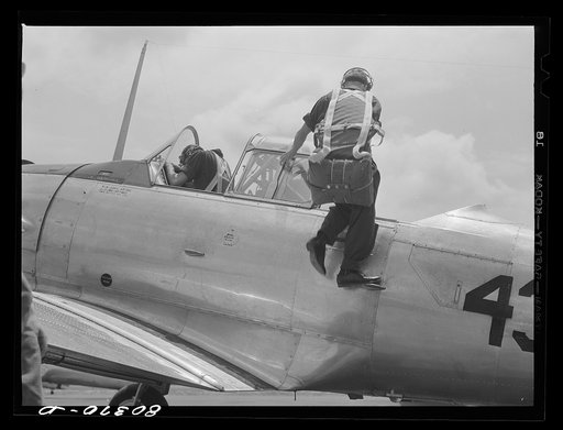 Cadet mounting plane prior to training flight. Craig Field, Southeastern Air Training Center, Selma, Alabama