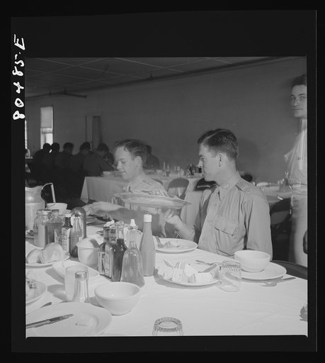 Untitled photo, possibly related to: "Like real home-cooked chicken" say these Craig Field flying cadets, in praise of the tender FSA (Farm Security Administration) "Food for Defense" chickens. Craig Field, Southeastern Air Training Center, Selma, Alabama