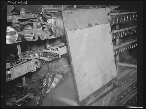 Cans, after sterilizing in steam, travel in conveyor belt to canning room. Phillips Packing Company, Cambridge, Maryland