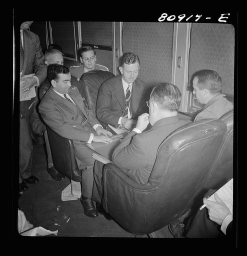 Commuters playing bridge on train to New York City