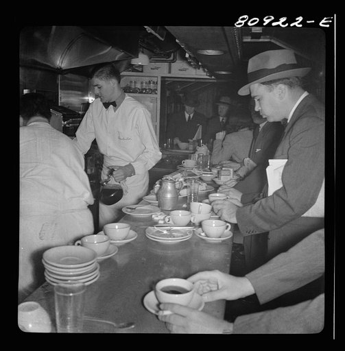 Commuters on train to New York City. Dining car counter