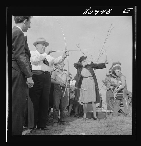 Indian braves instructing visitors in the art of yeomanry at five shots for a nickel. Local Indian association-sponsored Indian fair at Windsor Locks, Connecticut