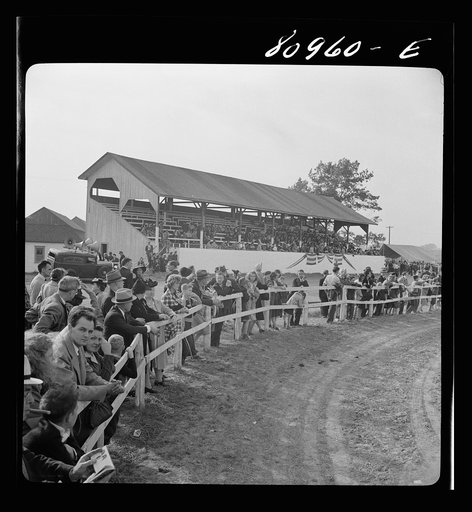 Windsor Locks, Connecticut. Crowd witnessing performers at the Indian fair to the accompaniment of Gene Autry singing "Below the Border." The local Indian association sponsored the Indian fair
