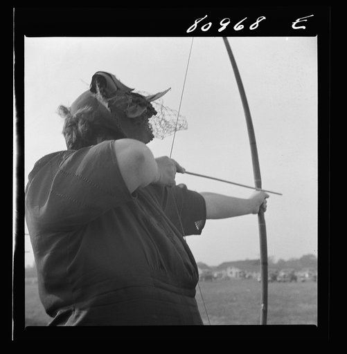 Windsor Locks, Connecticut. A visitor learning to shoot bows and arrows at five shots for a nickel at the Indian fair sponsored by the local Indian association