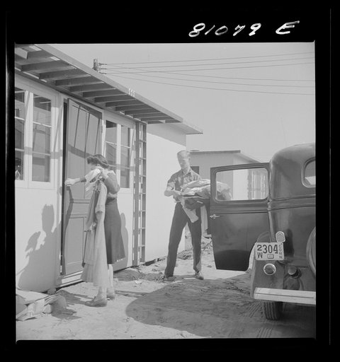 Untitled photo, possibly related to: Between shifts at the defense plant this FSA (Farm Security Administration) tenant moves into FSA defense housing project. Hartford, Connecticut