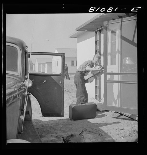 Between shifts at the defense plant this FSA (Farm Security Administration) tenant moves into FSA defense housing project. Hartford, Connecticut
