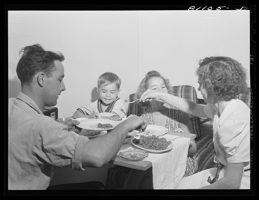 This family is having its first meal in their new home. FSA (Farm Security Administration) defense housing project. Hartford, Connecticut