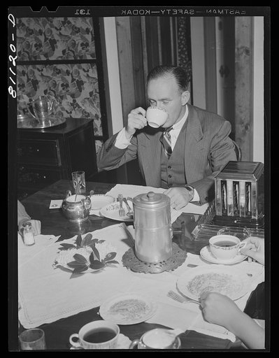 Last cup of coffee gulped down by Westport commuter before he dashes for the 7:40 a.m. commuter special for New York. Westport, Connecticut