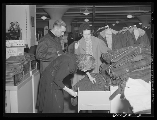 Farmer and his wife looking over winter clothing at the Syracuse Sears Roebuck store in New York