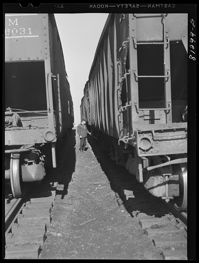 Freight cars loaded with coal waiting at dockside. Oswego, New York