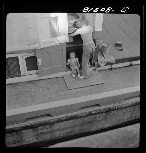 Untitled photo, possibly related to: This barge wife is "painting" up the ship. Erie Canal, New York