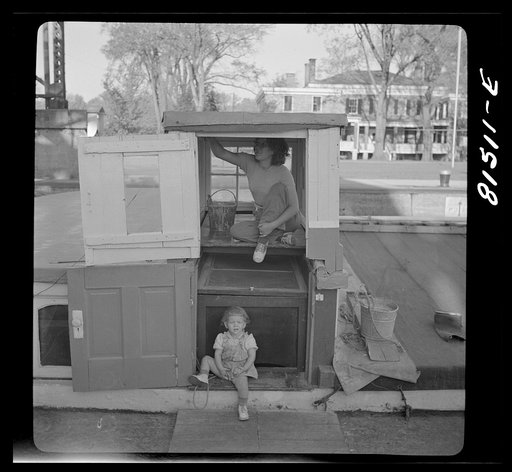 This barge wife is "painting" up the ship. Erie Canal, New York