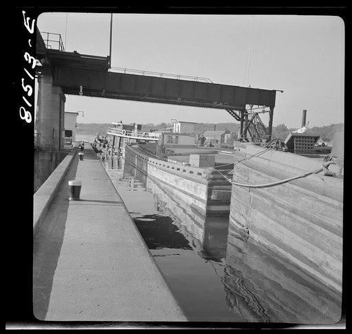 Tug pulling barges through Lock Eleven. Erie Canal, New York