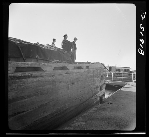 Untitled photo, possibly related to: Barges being pulled through by winch, prior to picking towline from tug. Erie Canal, New York