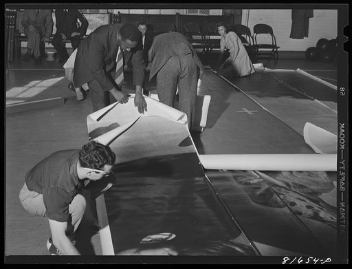 Untitled photo, possibly related to: Washington, D.C. Preparing the defense bond sales photomural, to be installed in the Grand Central terminal, New York, in the visual unit of the FSA (Farm Security Administration). Laying out finished prints for inspection
