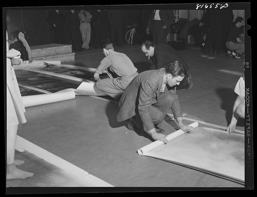 Untitled photo, possibly related to: Washington, D.C. Preparing the defense bond sales photomural, to be installed in the Grand Central terminal, New York, in the visual unit of the FSA (Farm Security Administration). Laying out finished prints for inspection