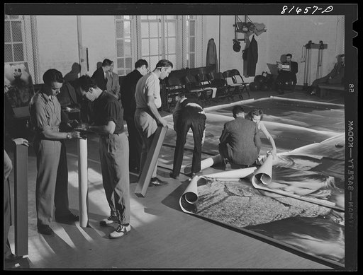 Washington, D.C. Preparing the defense bond sales photomural, to be installed in the Grand Central terminal, New York, in the visual unit of the FSA (Farm Security Administration). Laying out finished prints for inspection
