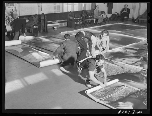 Washington, D.C. Preparing the defense bond sales photomural, to be installed in the Grand Central terminal, New York, in the visual unit of the FSA (Farm Security Administration). Laying out finished prints for inspection
