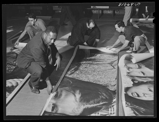 Untitled photo, possibly related to: Washington, D.C. Preparing the defense bond sales photomural, to be installed in the Grand Central terminal, New York, in the visual unit of the FSA (Farm Security Administration). Laying out finished prints for inspection
