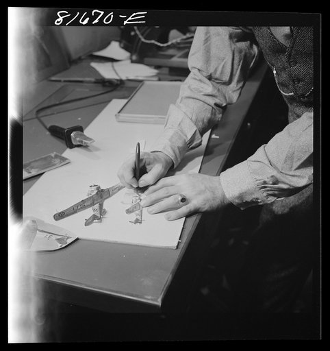 Washington, D.C. Preparing the defense bond sales photomural, to be installed in the Grand Central terminal, New York, in the visual unit of the FSA (Farm Security Administration). Milton Tinsley mounting part of the dummy