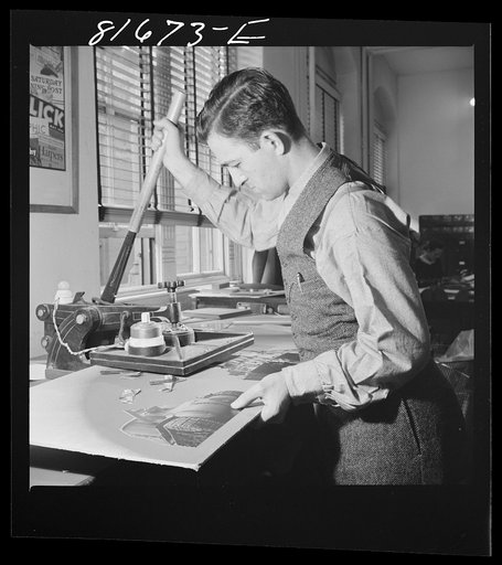 Untitled photo, possibly related to: Washington, D.C. Preparing the defense bonds sales photomural, to be installed in the Grand Central terminal, New York, in the visual unit of the FSA (Farm Security Administration). Milton Tinsley mounting parts of the dummy