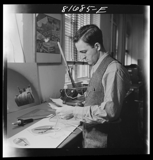 Untitled photo, possibly related to: Washington, D.C. Preparing the defense bonds sales photomural, to be installed in the Grand Central terminal, New York, in the visual unit of the FSA (Farm Security Administration). Milton Tinsley mounting parts of the dummy