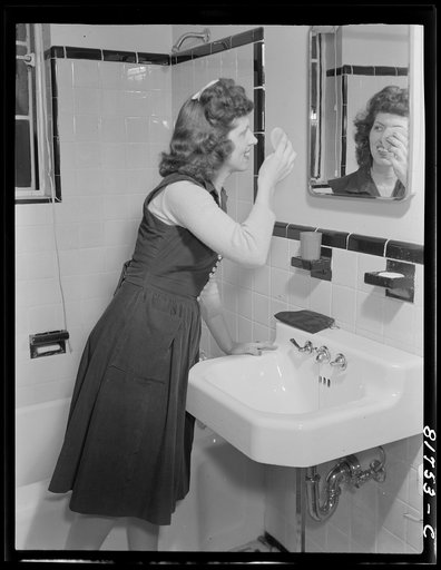 Stenographer has the use of a tiled bathroom in which to powder her nose and wash while she works for the Foreign Function Bureau, which is housed in a converted apartment building. Washington, D.C.