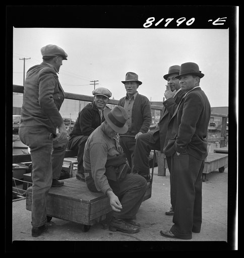 Italian fishermen gathered on Fisherman's Wharf, on December 8th, after the Japanese attack on Pearl Harbor. San Francisco, California