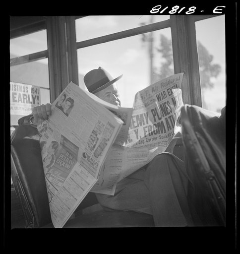 Reading war news aboard streetcar. San Francisco, California