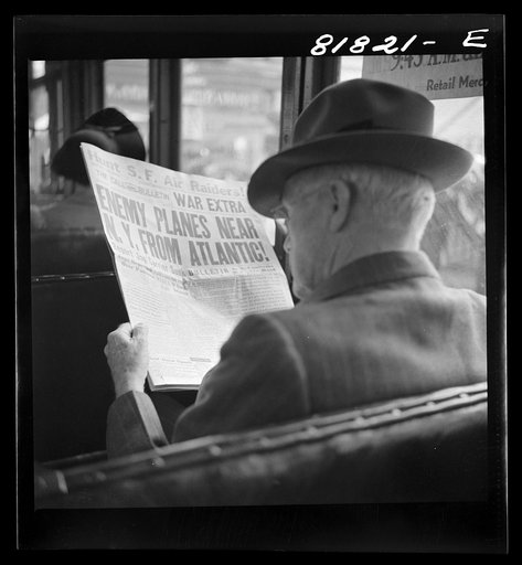 Reading war news aboard streetcar. San Francisco, California