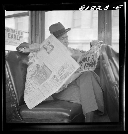 Untitled photo, possibly related to: Reading war news aboard streetcar. San Francisco, California