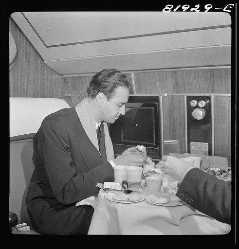 Untitled photo, possibly related to: Serving dinner aboard American airliner from Washington, D.C. to Los Angeles