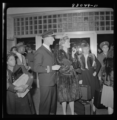 Washington, D.C. Christmas rush in the Greyhound bus terminal. Naval officer and his wife