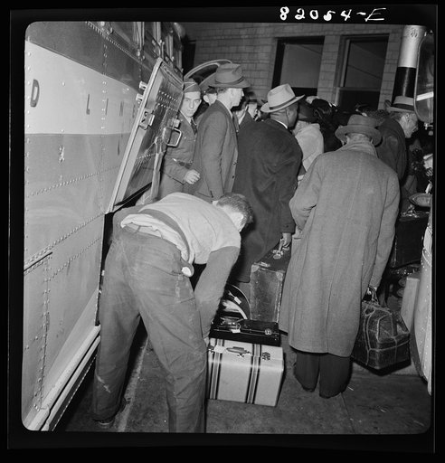 Washington, D.C. Christmas rush in the Greyhound bus terminal. Passengers leaving a bus