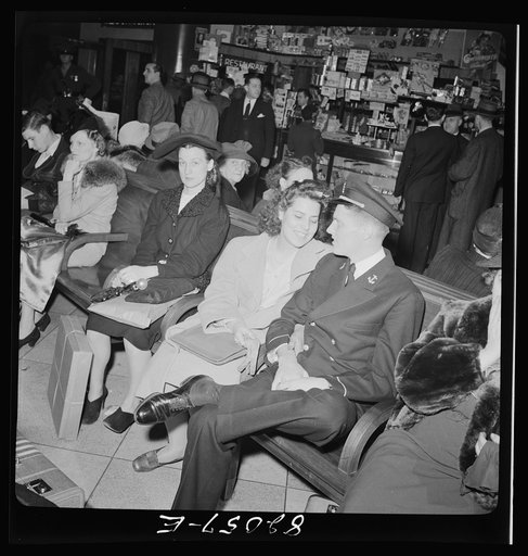 Washington, D.C. Christmas rush in the Greyhound bus terminal. Young lady and Naval officer