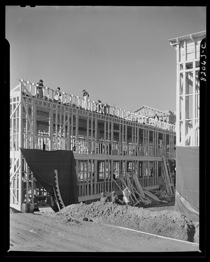 Untitled photo, possibly related to: Nailing up asbestos rock wall board on emergency defense office space construction project. Washington, D.C.