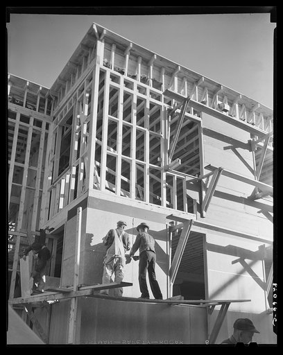 Untitled photo, possibly related to: Washington, D.C. Construction work to provide emergency defense office space. Nailing up asbestos rock wall board