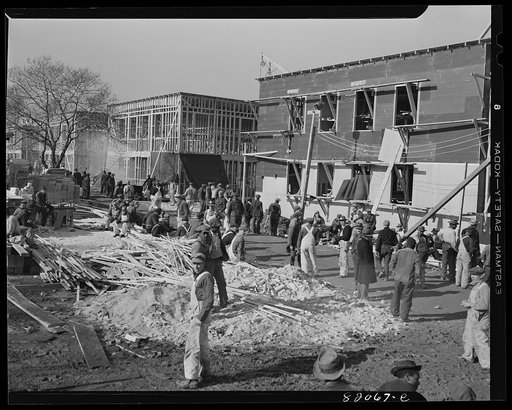 Untitled photo, possibly related to: Nailing up asbestos rock wall board on emergency defense office space construction project. Washington, D.C.
