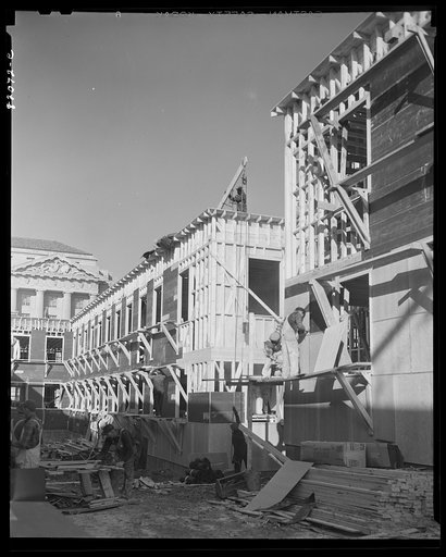 Untitled photo, possibly related to: Nailing up asbestos rock wall board on emergency defense office space construction project. Washington, D.C.