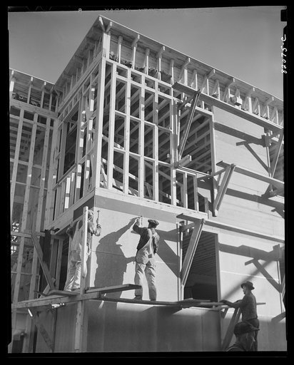 Washington, D.C. Construction work to provide emergency defense office space. Nailing up asbestos rock wall board