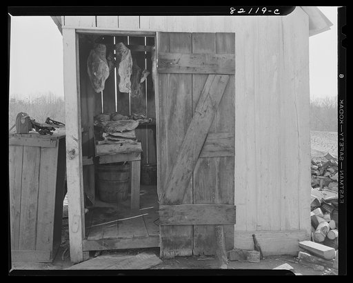 Untitled photo, possibly related to: Cured pork hanging in the meat house of a Negro FSA (Farm Security Administration) client at Calvert County, Maryland