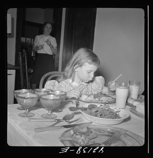 Little girl on a farm in Maryland, learning to eat vitamins