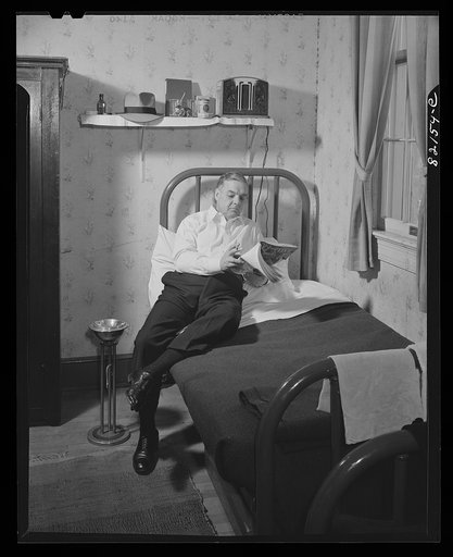 Washington, D.C. Self-help client in his room in self-help house, where he pays for his room with scrip earned as timekeeper in the self-help exchange