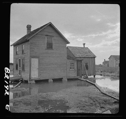 Dorchester County, Maryland. High tide sweeps under the floor of this "waterman's" home on Gibson Island