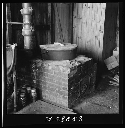 Untitled photo, possibly related to: Honey Brook, Pennsylvania (vicinity). Dutch stove used for boiling down meat and bone scraps for soup jelly. Amish FSA (Farm Security Administration) client's home