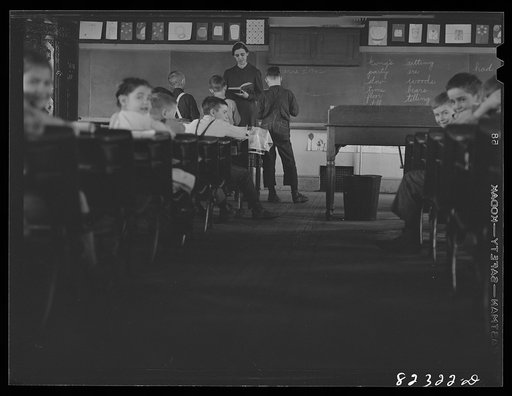 Untitled photo, possibly related to: Hinkletown, Pennsylvania (vicinity). Mennonite teacher holding class in one-room, eight grade school house