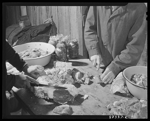 Honey Brook, Pennsylvania (vicinity). Amish man and wife cutting up beef for canning