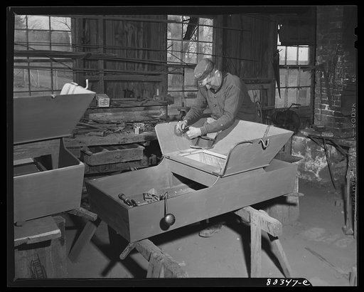 Intercourse, Pennsylvania (vicinity). Amish wagon shop. Man is not Amish, but a blacksmith hired by the shop