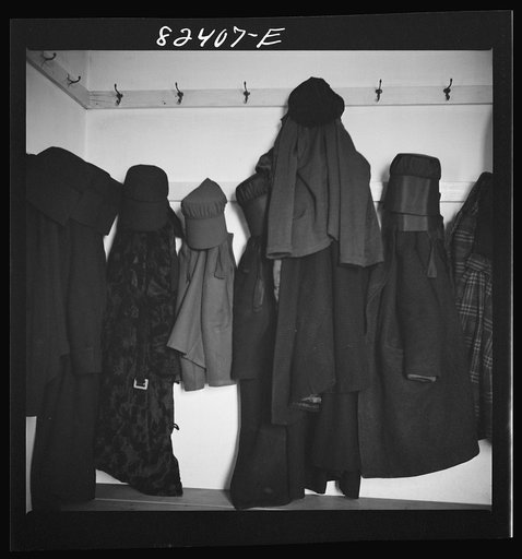 Hinkletown, Pennsylvania (vicinity). Girls' cloaks and bonnets hanging in church during "Deutsch school"