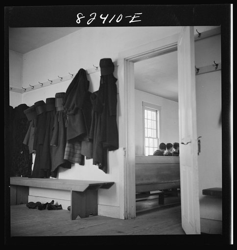Hinkletown, Pennsylvania (vicinity). Girls' cloaks and bonnets hanging in church during "Deutsch school"